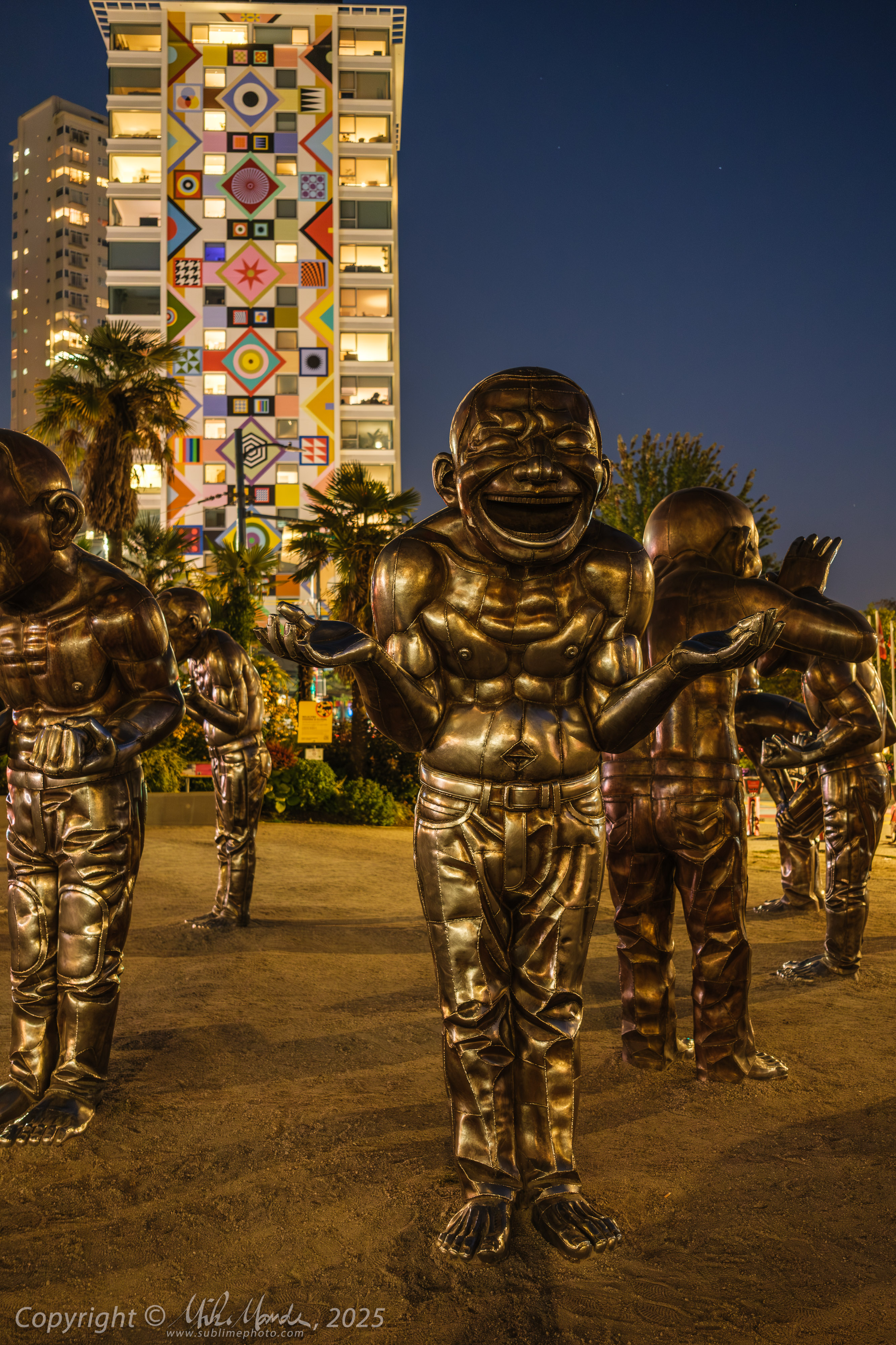 Laughing men statues at night in Vancouver, BC